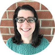 danielle-barre A smiling brunette woman in glasses